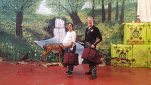 Load image into Gallery viewer, Bjarne and his then pregnant Wife holding the two burgundy Midwater Bow Bags folded down