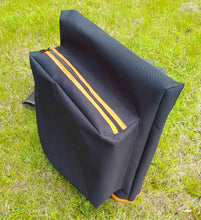 Load image into Gallery viewer, Midwater Chair Tidy in black and mad orange on the grass