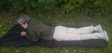 Load image into Gallery viewer, side view Midwater Large Species Mat with 5 ft 5 inch lady lay on the open mat for size comparison