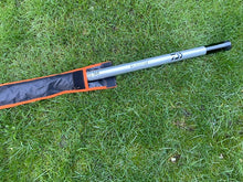 Load image into Gallery viewer, Midwater Pole Sleeve in black and mad orange colour on the grass with a recognisable pole in position