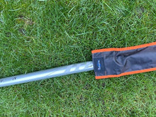 Load image into Gallery viewer, Midwater Pole Sleeve in black and mad orange colour on the grass with a recognisable pole in position