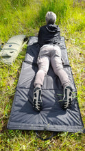 Load image into Gallery viewer, Midwater Range Mat in black with 5 ft 5 inch lady lay in the prone position on the range mat.