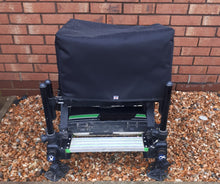 Load image into Gallery viewer, A black seat box cover fitted on a seatbox, placed outdoors with a brick wall in the background.